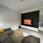 Modern wood panel entertainment unit with storage cabinets under the TV – Hills Wide Kitchens