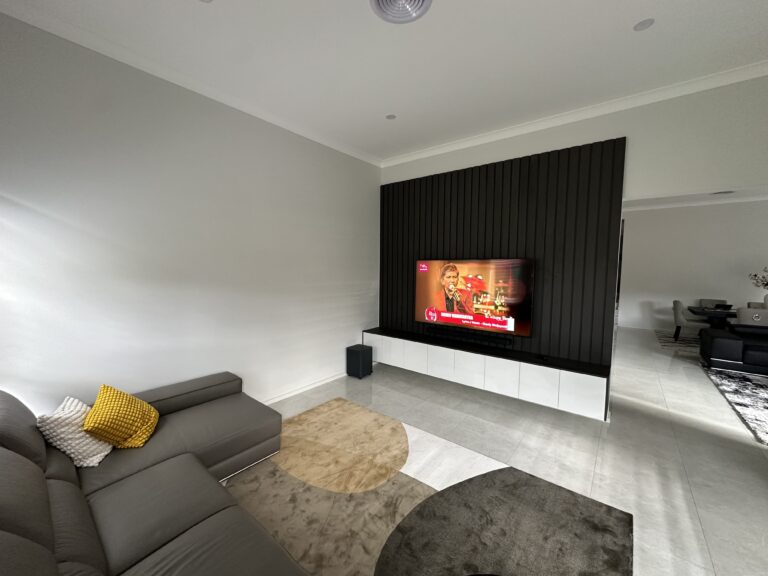 Modern wood panel entertainment unit with storage cabinets under the TV – Hills Wide Kitchens